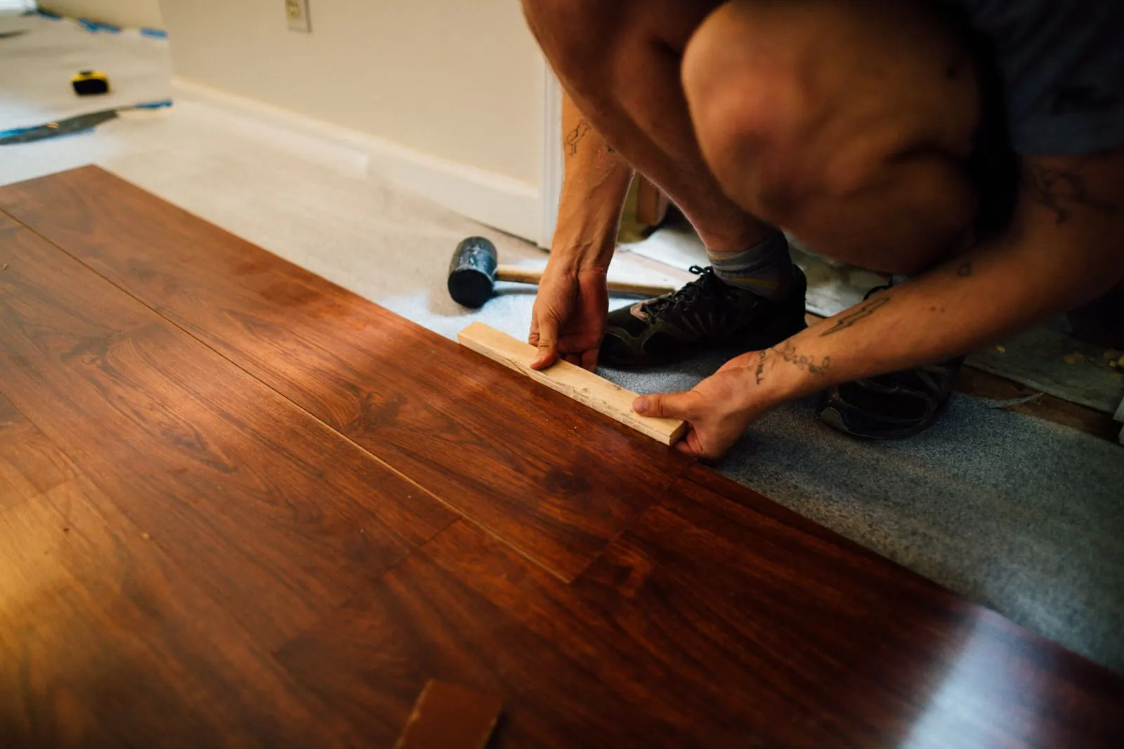 Installer fitting hardwood-look flooring planks