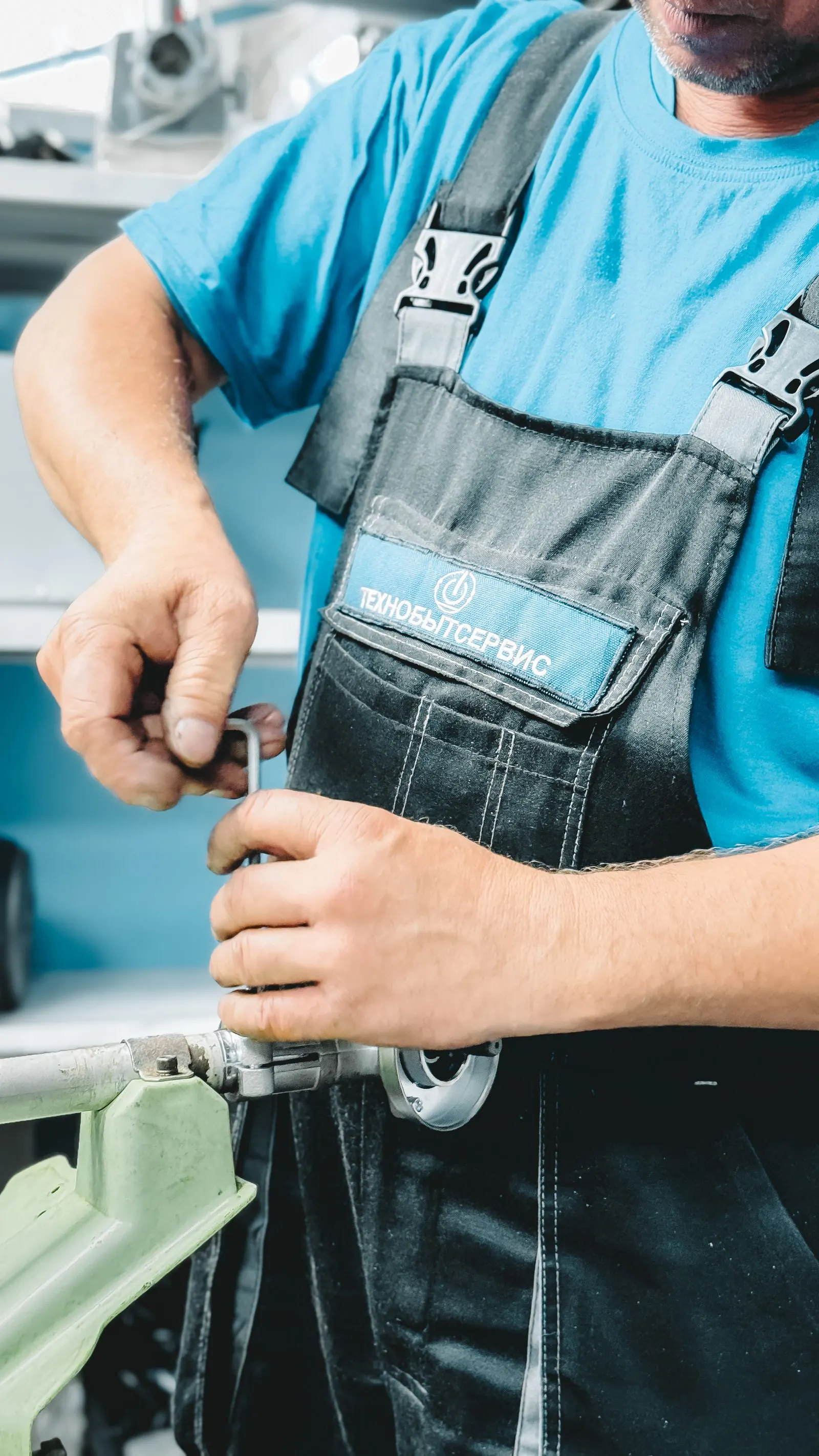 Repair worker tightening a pipe fitting with a wrench