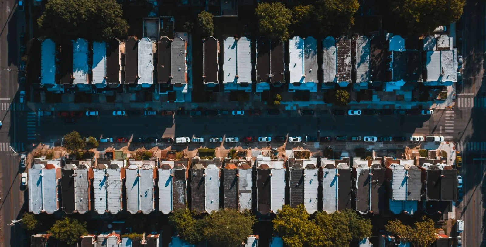Drone view looking down on rows of Philadelphia rowhouse roofs