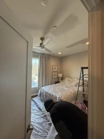 Bedroom prep with floors covered before painting and repairs