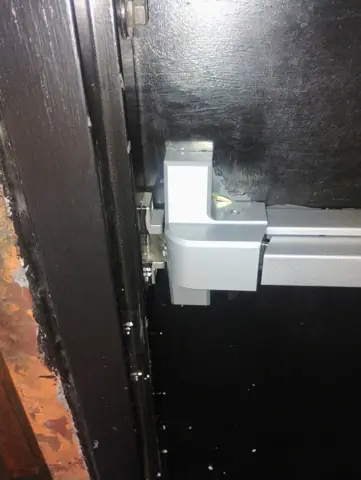 Black steel door with new commercial handle hardware