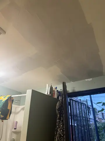 Ceiling and wall repair near a balcony door
