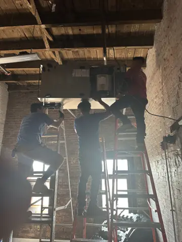 Ceiling framing work on scaffolding in an open space