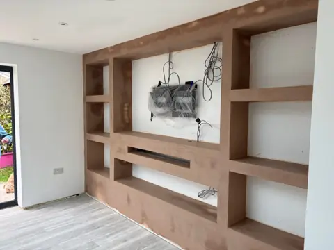 Custom wood built-in entertainment wall with shelving