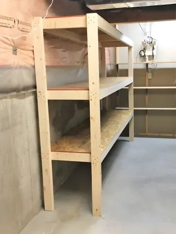 Custom wood storage shelving built in a basement