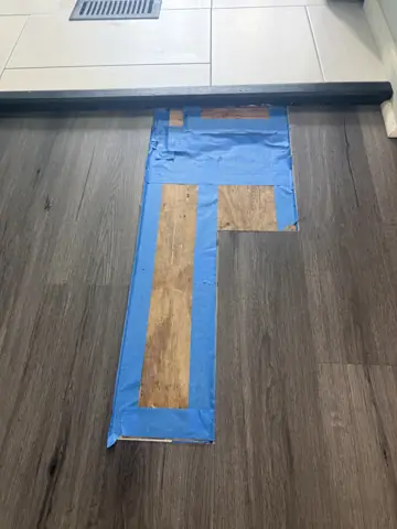 Damaged floor boards cut out and patched during a flooring repair