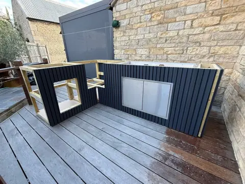 Finished outdoor kitchen island on a stone patio