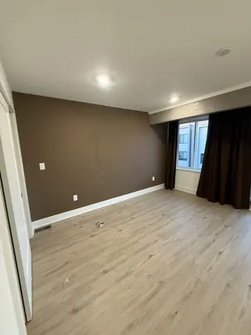 Freshly painted bedroom with an accent wall and new flooring