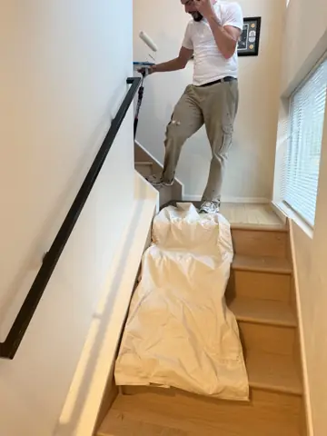 Installing a black handrail along a stairway