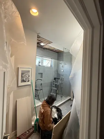 Installing a new glass shower enclosure in a bathroom