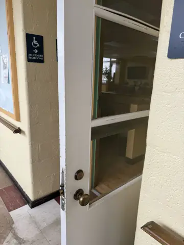 Interior door with glass panel installed in a commercial space