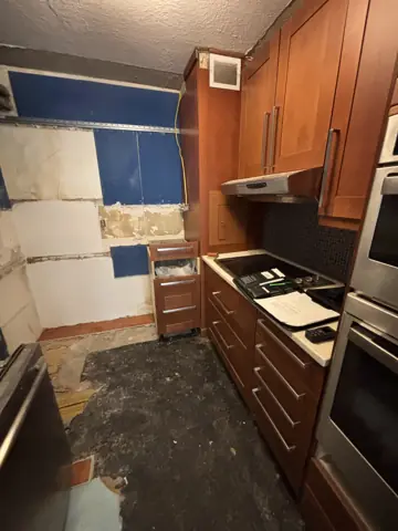 Kitchen demolition with old backsplash and drywall removed