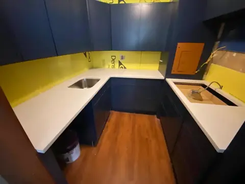Kitchen remodel with navy cabinets and a white quartz counter