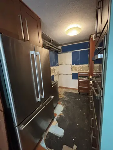 Kitchen renovation in progress around the refrigerator