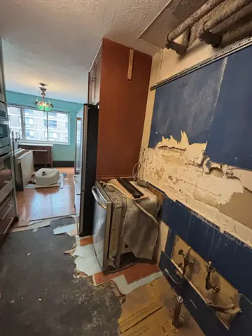Kitchen wall stripped for new drywall and backsplash