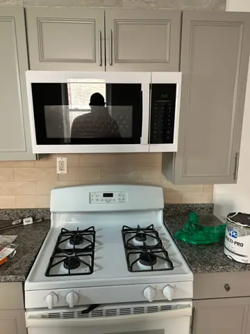 Kitchen with a new range and over-the-range microwave installed