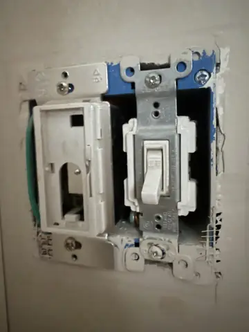 Light switch and dimmer being replaced in a wall box