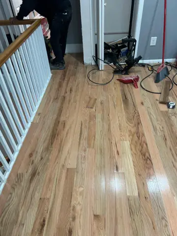 New hardwood flooring installed by a staircase