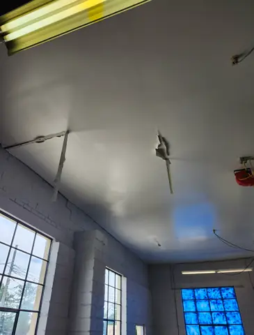 Painted ceiling in a room with glass block windows