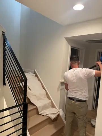 Painting a stairwell with a modern metal railing