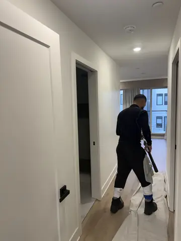 Painting walls and trim in a newly finished hallway