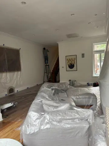 Room covered in plastic sheeting for dust control during repairs