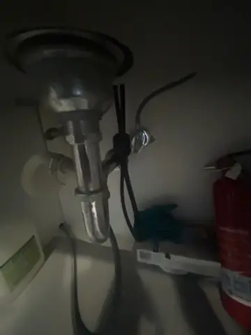 Under-sink drain and supply line repair in a bathroom vanity