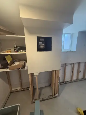 Wall opened at the base to the studs during a water-damage repair