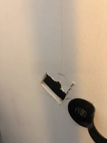 Wall outlet box opened up for an electrical fixture install