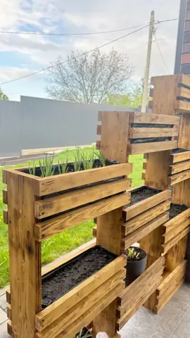 Wooden planter wall built for a backyard